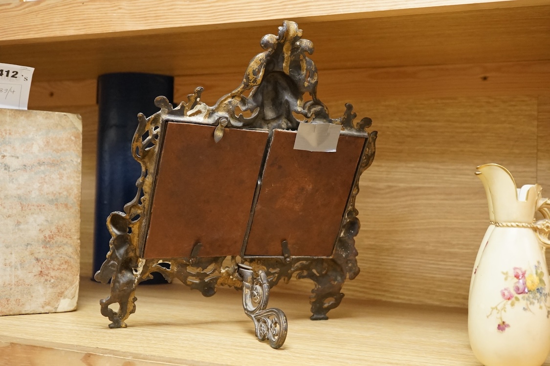 A cast brass putti double easel photo frame, 34cm high